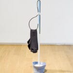 Walter Scott, Jonas, 2018, wood, hat, t-shirt, hair-tie, metal, 17 x 46 x 12 inches. Installation view, Walter Scott: Betazoid in a Fog, Remai Modern, 2018. Photo: Blaine Campbell.