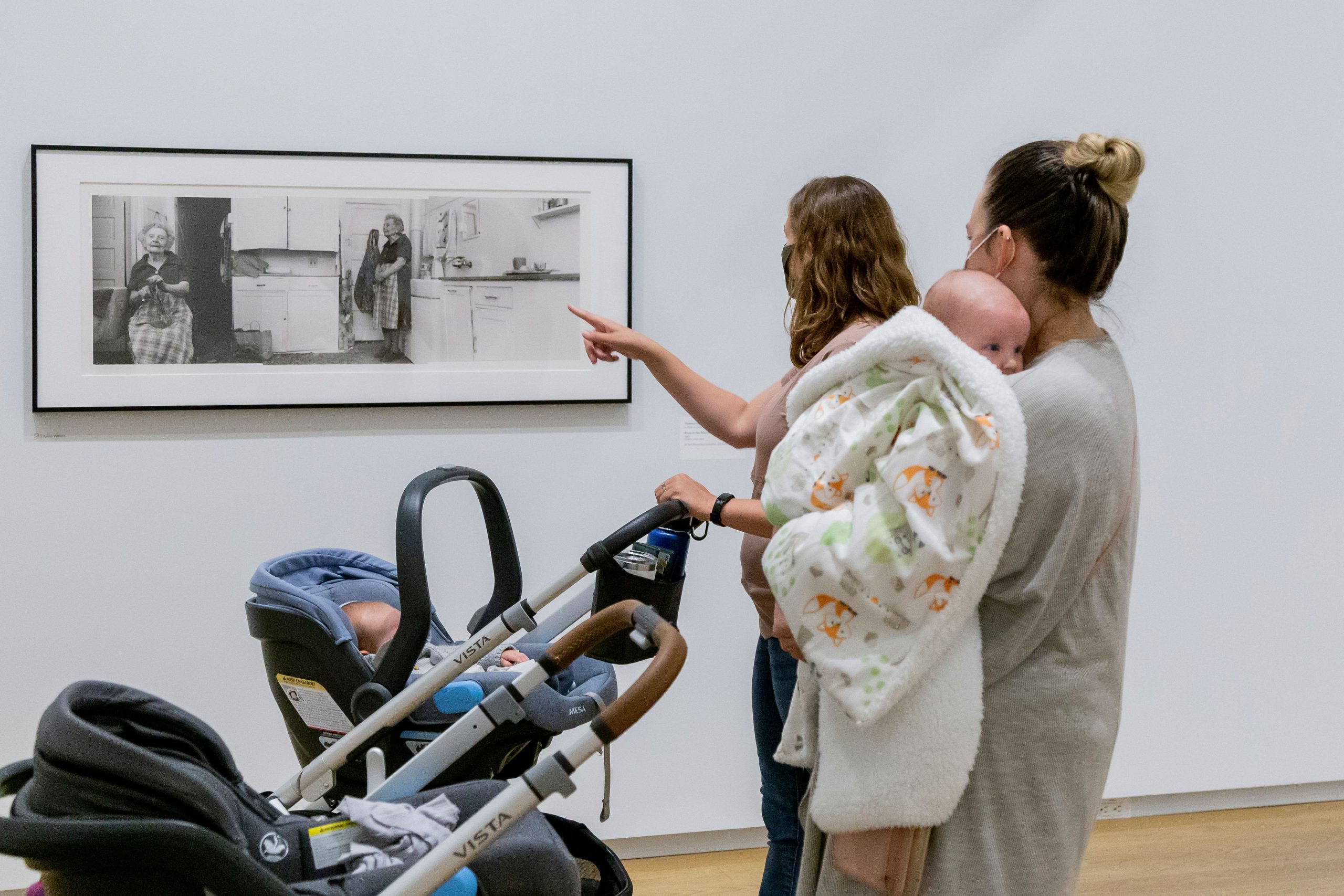 2 people and a baby on a stroller tour at the museum