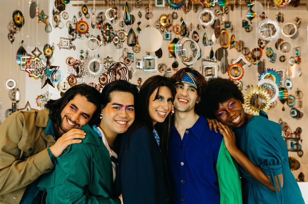 A group of models pose in LUGO-inspired outfits in front of the Nick Cave installation at the museum.