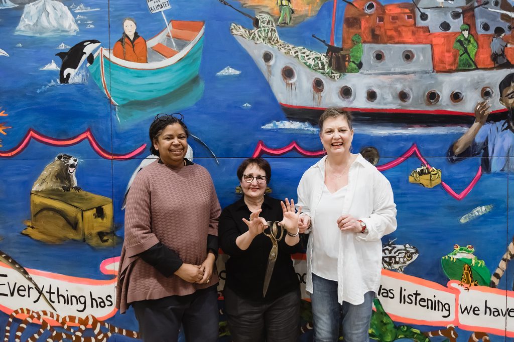 From left to right: Curator Michelle Jacques, Betsy Rosenwald, and Dawna Rose celebrate the official mural unveiling.