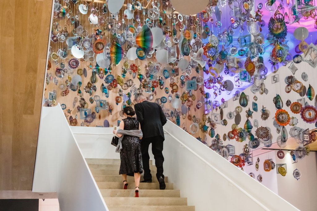 2 people walk up the stairs in Remai Modern's Atrium