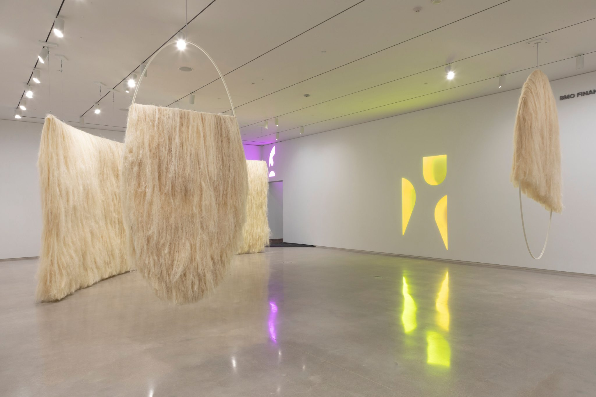 A photo of the exhibition Remediation featuring large scale scupltures made of dried grass material