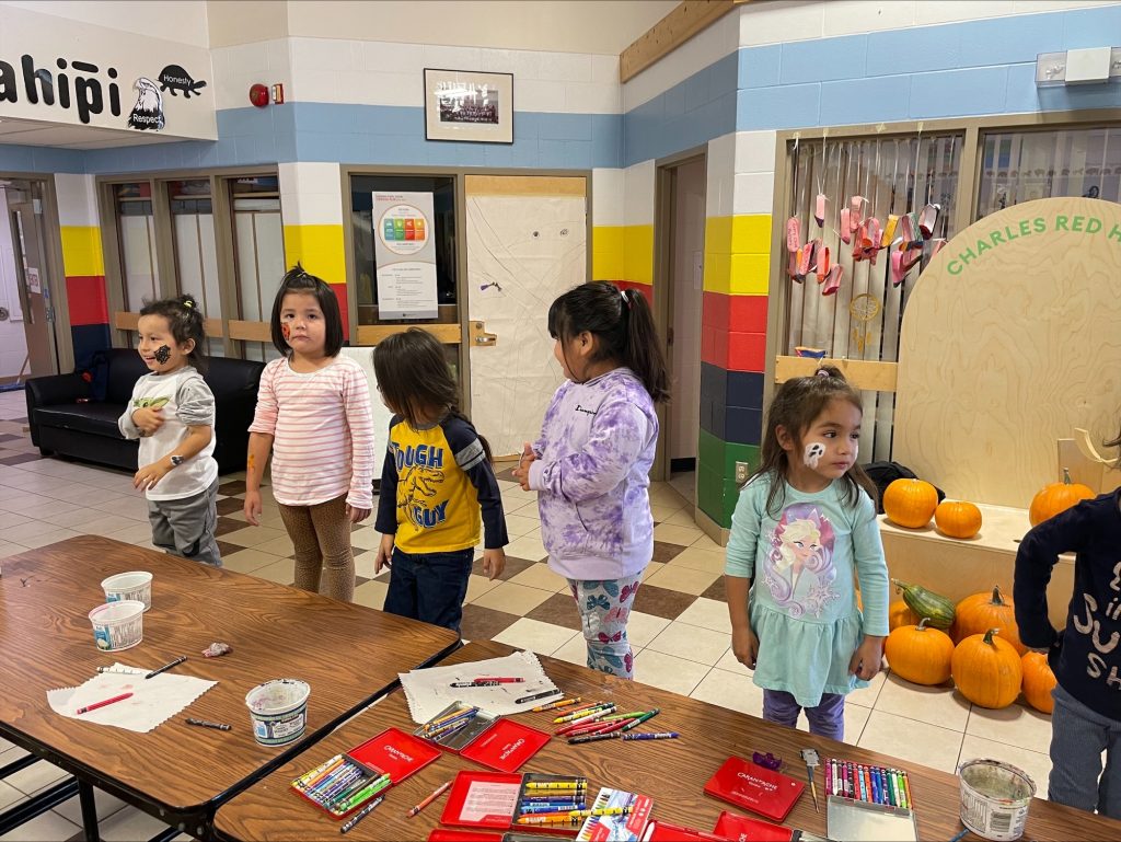 Students make art at Charles Red Hawk school.