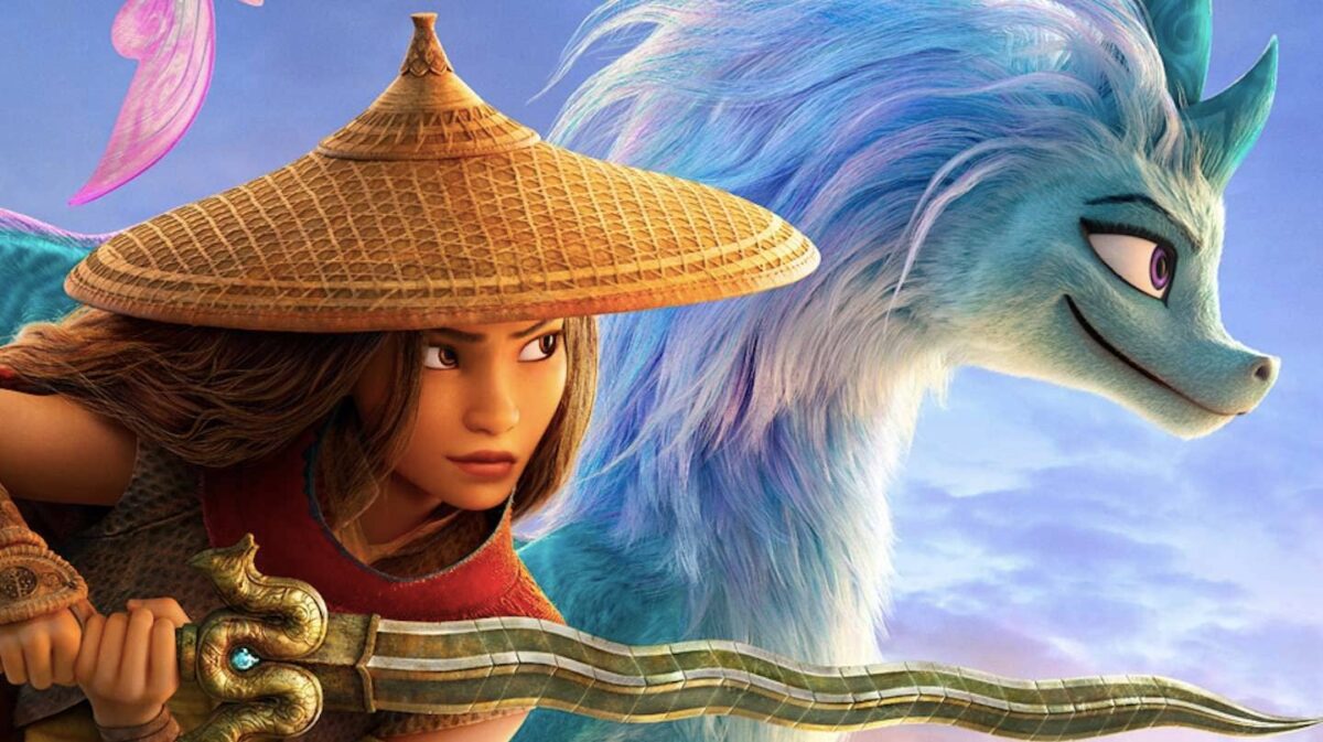 A person holding a sword stands beside a dragon