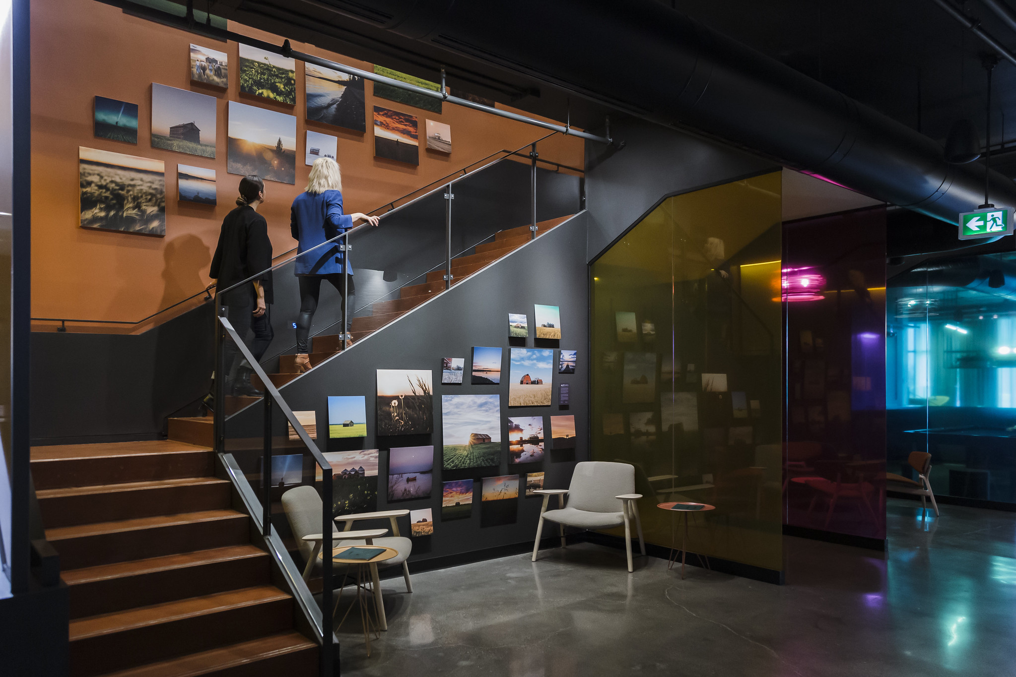 A stairwell inside the Alt Hotel in Saskatoon with two people walking up them.